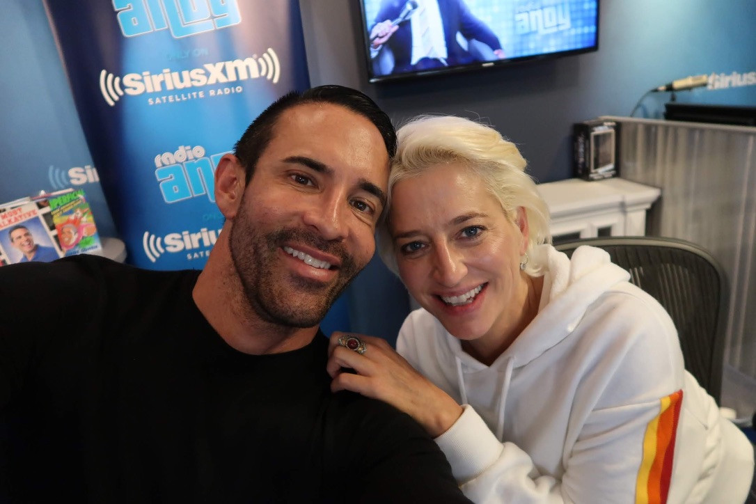 Jorge Cruise and Dorinda Medley smiling together in the SiriusXM Radio Andy studio